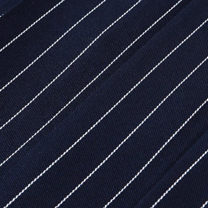 FJØRNA Y2K striped strapless mini dress featuring bold colorful vertical stripes and a fitted, stylish design.