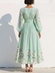 FJØRNA women's floral summer midi dress with a V-neck, flowy fabric, and a stylish design perfect for warm weather.