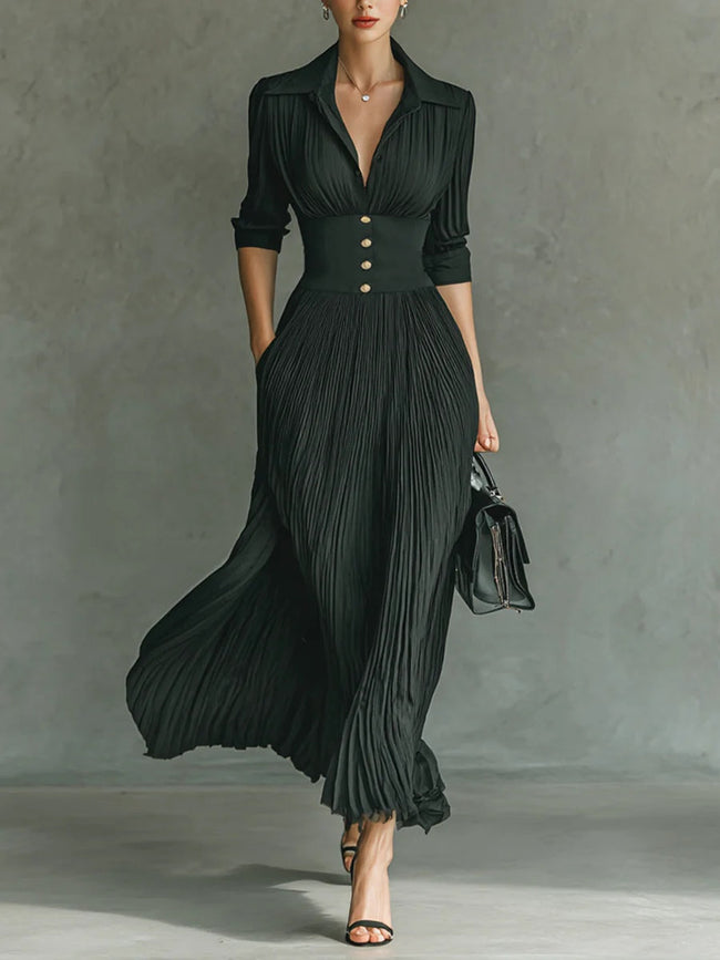 Elegant FJØRNA women's maxi dress with V-neck and pleated design, featuring a flowing silhouette and soft fabric.