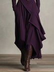 FJØRNA summer maxi dress for women with high neck and long sleeves, flowing fabric, in a vibrant color, suitable for warm weather.