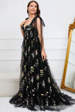 Black FJØRNA Macy trendy tulle A-line evening dress with elegant flowy fabric and fitted bodice, perfect for formal occasions.
