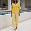 Yellow striped high-waist two-piece summer set for women by FJØRNA, featuring a stylish co-ord outfit with a crop top and matching skirt.