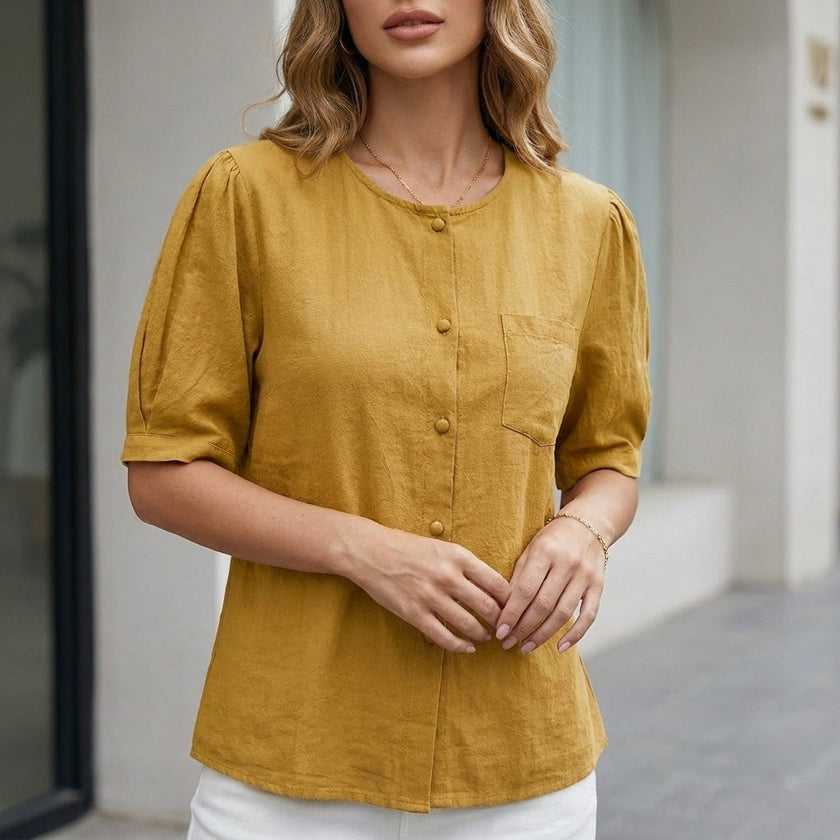 Yellow FJØRNA women's summer blouse with short sleeves and front pockets, made of lightweight linen fabric.