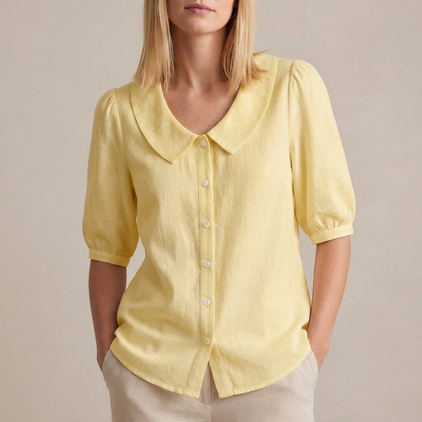 Yellow women's summer blouse with puff sleeves and button front, made of linen by FJØRNA.