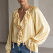 Yellow women's summer blouse with V-neck and lace details, stylish top from FJØRNA for warm-weather fashion.