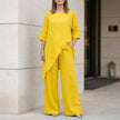 Yellow FJØRNA relaxed two-piece set with flowing wide-leg pants, stylish and comfortable for casual or elegant wear.