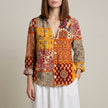 Yellow floral V-neck long sleeve linen summer blouse for women by FJØRNA, shown on a model.