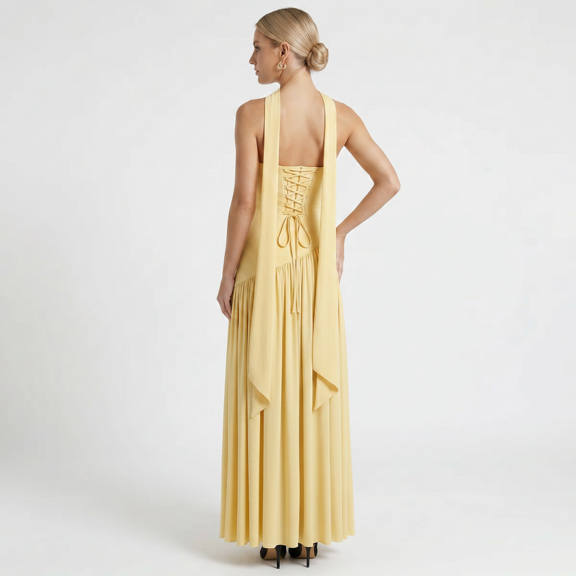Yellow women's elegant strapless maxi dress by FJØRNA, back view showcasing flowing fabric and fitted waist.