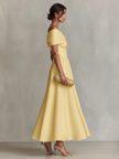 Yellow linen evening dress by FJØRNA, sleeveless with a flowing fit and elegant design, perfect for warm-weather occasions.