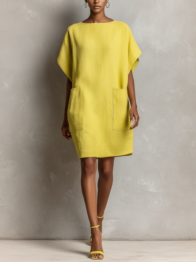 Yellow linen dress for women by FJØRNA, featuring a casual fit with short sleeves and a knee-length design.
