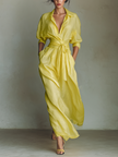 Yellow linen maxi dress for women by FJØRNA, featuring a flowing design and sleeveless style, displayed on a hanger.