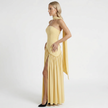 Yellow women's strapless maxi dress by FJØRNA shown from side profile, featuring a flowing silhouette and elegant design.