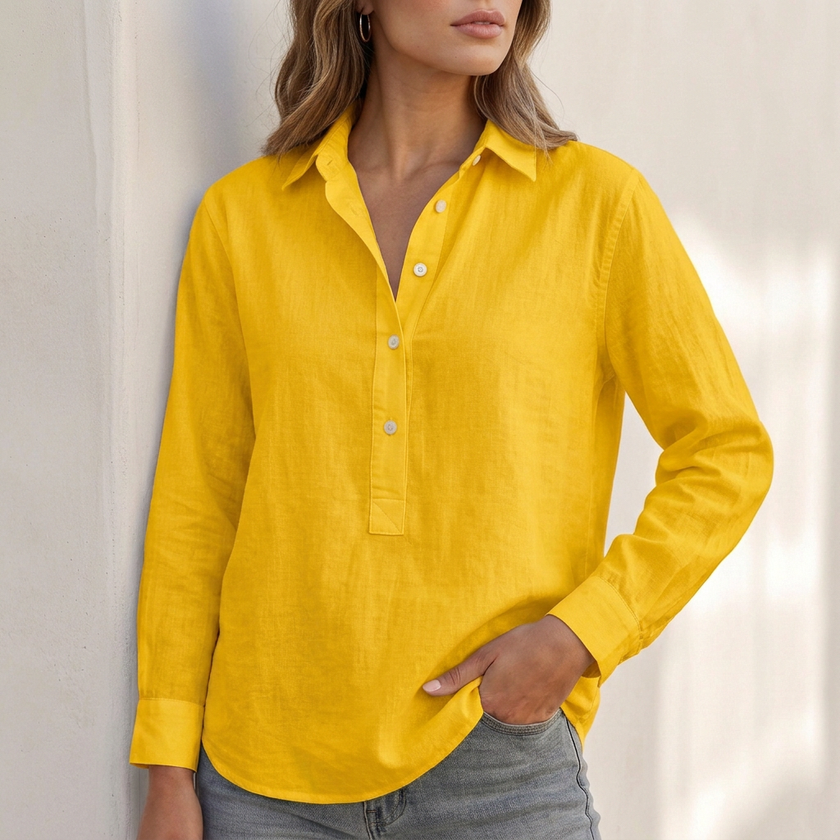 Yellow V-neck popover shirt for women with cuffed sleeves and relaxed fit by FJØRNA, shown on a model.
