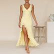 Yellow FJØRNA flowing chiffon maxi dress with ruched bodice and ruffled slit, perfect for elegant summer occasions.