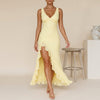 Yellow FJØRNA flowing chiffon maxi dress with ruched bodice and ruffled slit, perfect for elegant summer occasions.