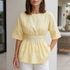 Yellow linen summer blouse for women by FJØRNA, flowy casual top with a relaxed fit and lightweight fabric.