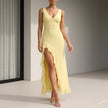 Yellow FJØRNA fitted sleeveless maxi dress with ruffles and high slit, flowing and elegant for summer wear.