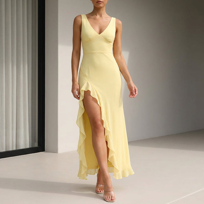 Yellow FJØRNA fitted sleeveless maxi dress with ruffles and high slit, flowing and elegant for summer wear.
