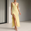 Yellow FJØRNA fitted sleeveless maxi dress with ruffles and high slit, flowing and elegant for summer wear.