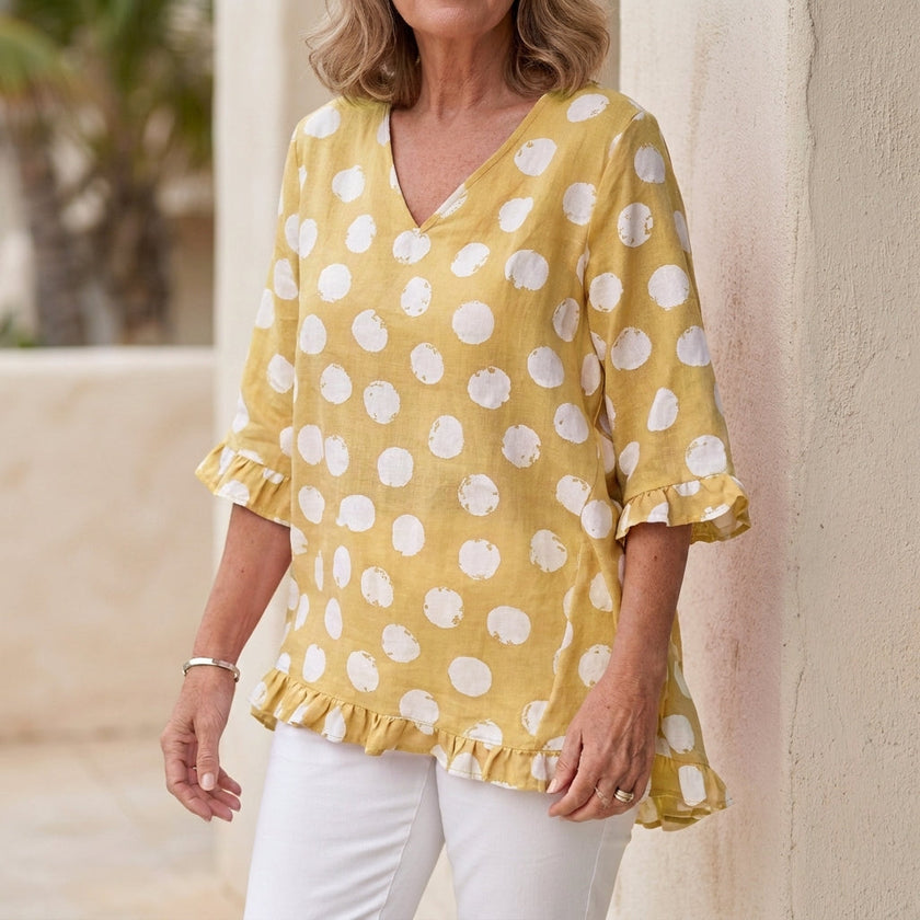 Yellow FJØRNA women's mini dress with V-neck and ruffle details, stylish and elegant for casual or special occasions.