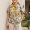 Yellow floral short sleeve summer blouse for women by FJØRNA, lightweight and stylish top with a vibrant floral pattern.