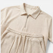 Men's textured zip polo shirt and shorts set in neutral tones, styled for summer casual wear, by FJØRNA.