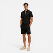 Men's textured zip polo shirt and shorts set by FJØRNA, perfect for summer casual wear, featuring a stylish zip neck design.