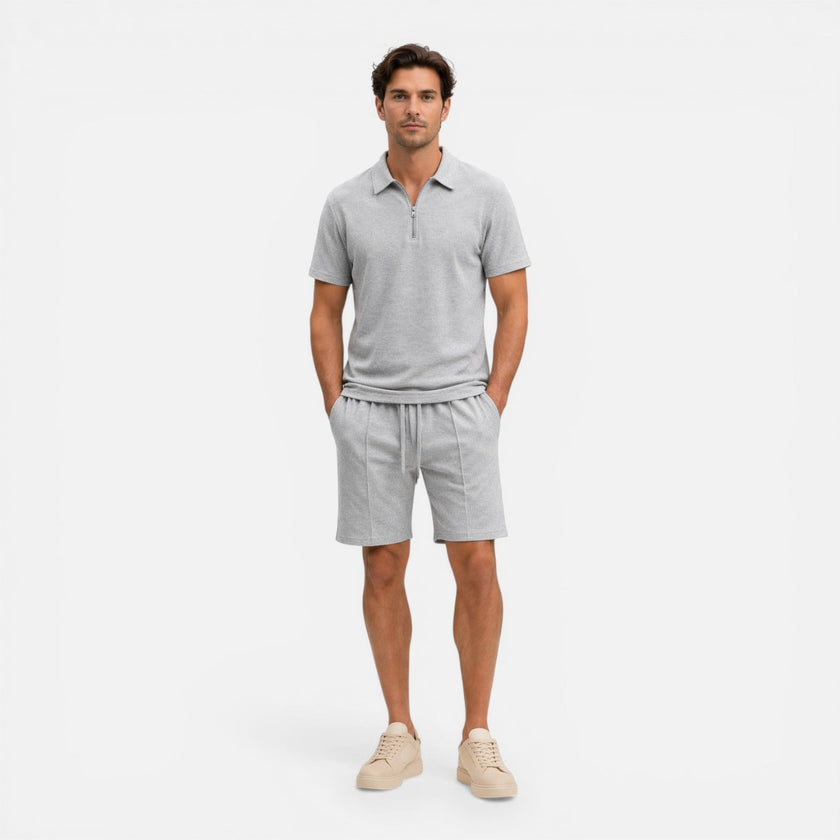 Men's textured zip polo shirt and shorts set in neutral tones, casual summer co-ord by FJØRNA, displayed on a hanger.