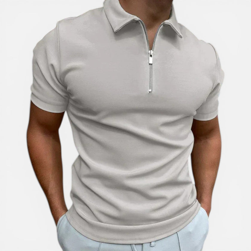 Men's slim fit zip polo shirt from FJØRNA with a classic collar and short sleeves, styled casually.