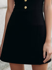 FJØRNA black sleeveless halter mini dress with white collar detail, stylish women's dress featuring a fitted silhouette and chic design.