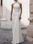 Elegant satin pleated halter-neck evening gown by FJØRNA, showcasing a flowing design with intricate pleats and a sophisticated silhouette.