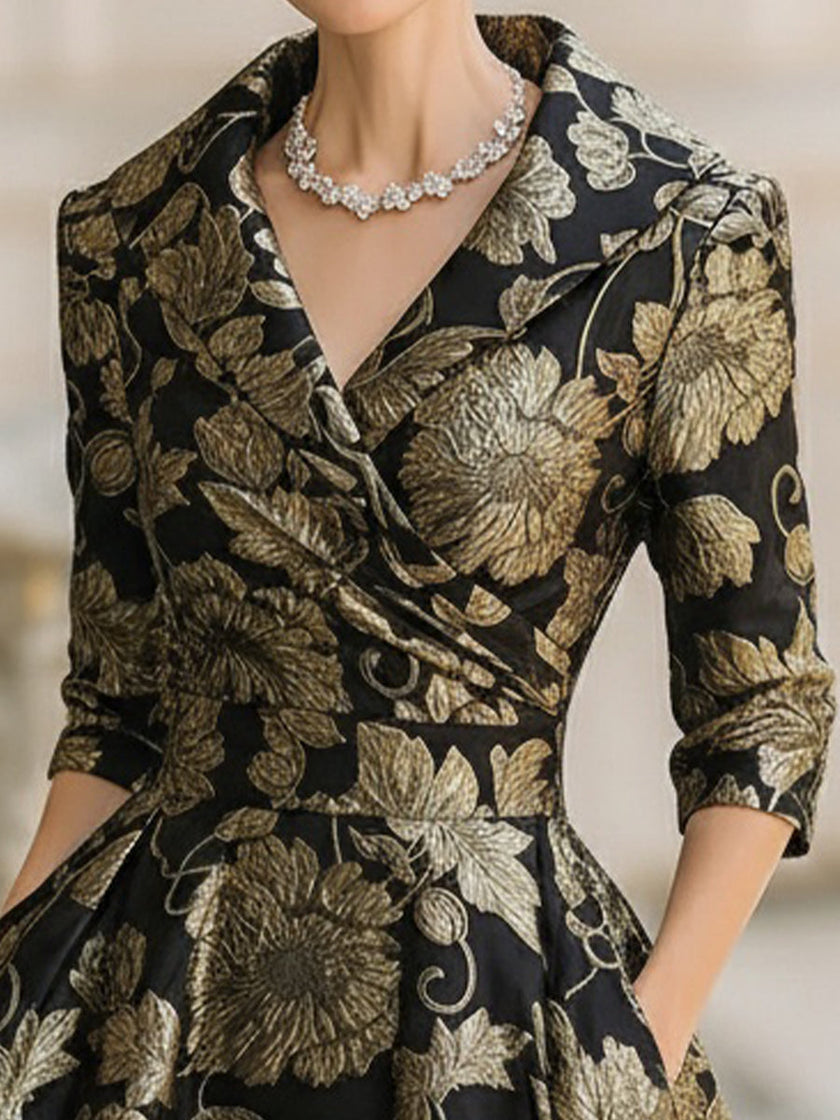 FJØRNA black and gold jacquard floral midi dress with elegant pattern and fitted silhouette, perfect for formal occasions.