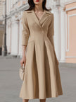FJØRNA beige blazer-style midi dress with tailored fit and classic lapel collar, perfect for sophisticated occasions.