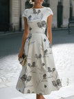 FJØRNA floral sketch print cap sleeve midi dress with a fitted waist and flowing skirt, perfect for spring and summer wear.