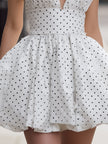 FJØRNA vintage halter polka dot bubble mini dress, perfect for summer or casual wear, featuring a retro style with a fitted silhouette.