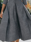 FJØRNA women's fit-and-flare midi dress with collar, button-front, and waist belt, shown on a model wearing the stylish dress.