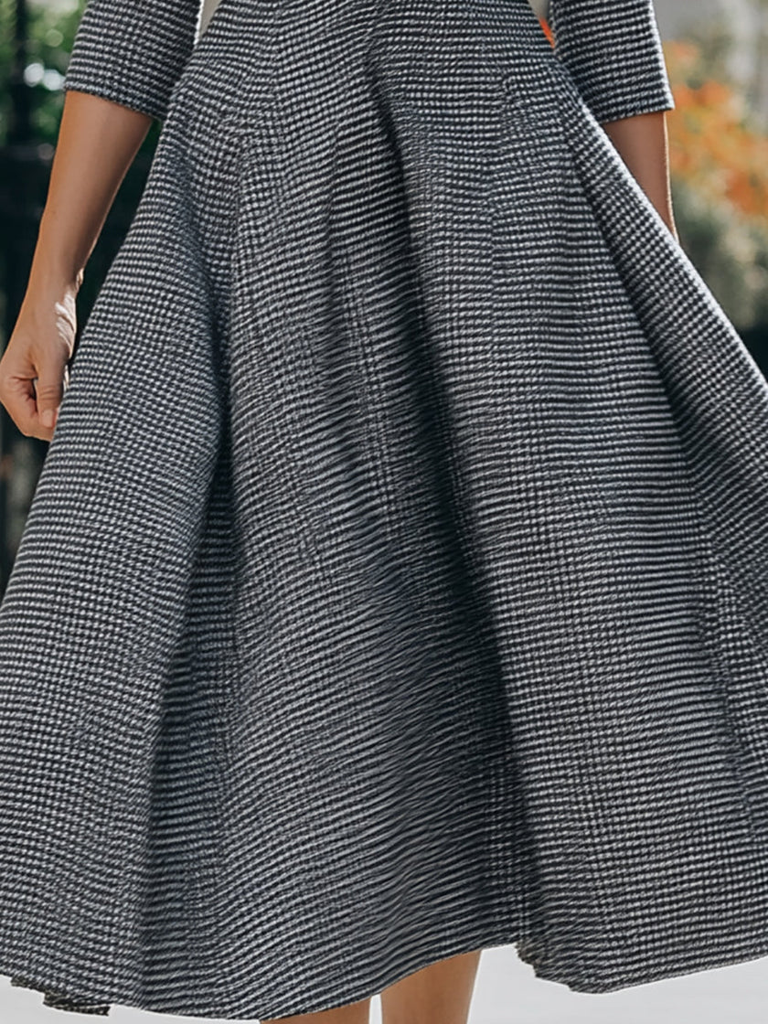 FJØRNA women's fit-and-flare midi dress with collar, button-front, and waist belt, shown on a model wearing the stylish dress.