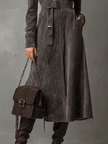 FJØRNA high neck belted suede midi dress displayed on a hanger, showcasing its elegant design and rich suede texture.