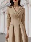 Beige blazer-style midi dress by FJØRNA, featuring a tailored blazer design, knee-length cut, and elegant fit.