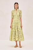 FJØRNA Ledina Maxi Green Dress shown on a hanger, featuring flowing fabric and elegant design for formal or casual occasions.