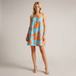 FJØRNA halter neck printed mini dress with flowy A-line fit, featuring vibrant floral patterns and a stylish, elegant design.