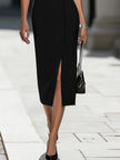 FJØRNA black and white contrast trim midi dress with sleeveless design and fitted silhouette, displayed on a mannequin.