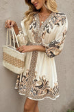 FJØRNA champagne printed V-neck lantern sleeve mini dress with waist tie, stylish and elegant for special occasions.