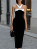 Black velvet midi dress by FJØRNA featuring a white halter neck bow detail and elegant fit for formal occasions.