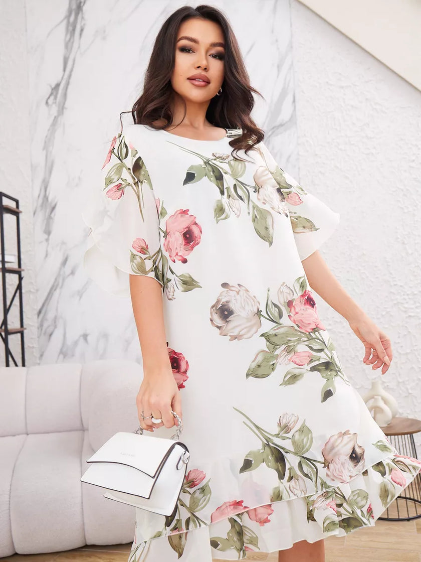 FJØRNA Violeta Elegante white dress with flowing gas fabric and dress design, perfect for sophisticated occasions.