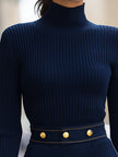 Navy ribbed knit dress by FJØRNA with gold-tone button accents and denim pocket details, perfect for women.
