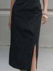 FJØRNA sleeveless pinstripe midi dress with tailored lapel collar, showcasing a sleek, professional women's dress design.