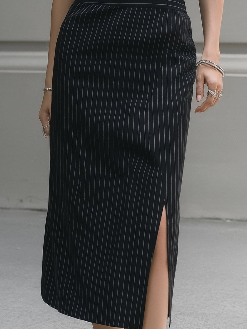 FJØRNA sleeveless pinstripe midi dress with tailored lapel collar, showcasing a sleek, professional women's dress design.