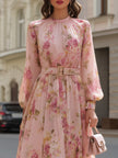 FJØRNA Romantic blush floral chiffon midi dress with flowing fabric and delicate floral pattern, perfect for elegant occasions.