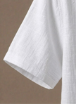 Men's FJØRNA linen beach shirt, lightweight and breathable men's polo with button-up design for summer wear.